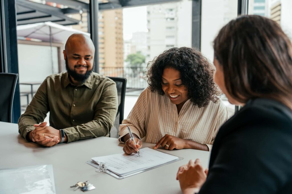 woman happily signing a contract
