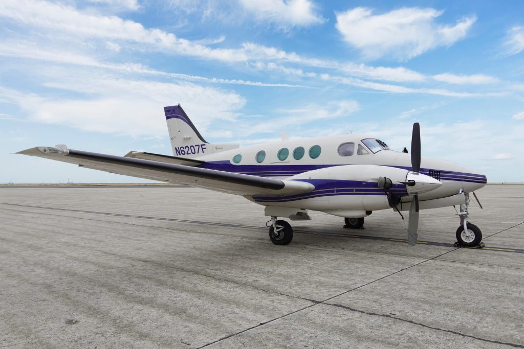 air new england's beechcraft king air C90 on the tarmac during a sunny day
