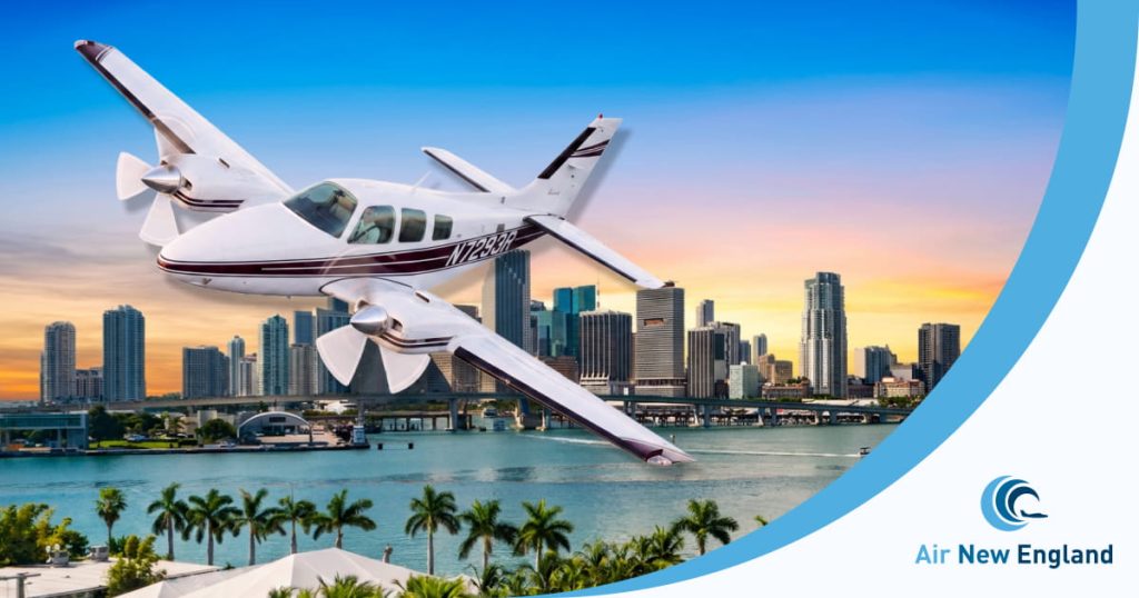 beechcraft baron flying in florida sunset with air new england private charter